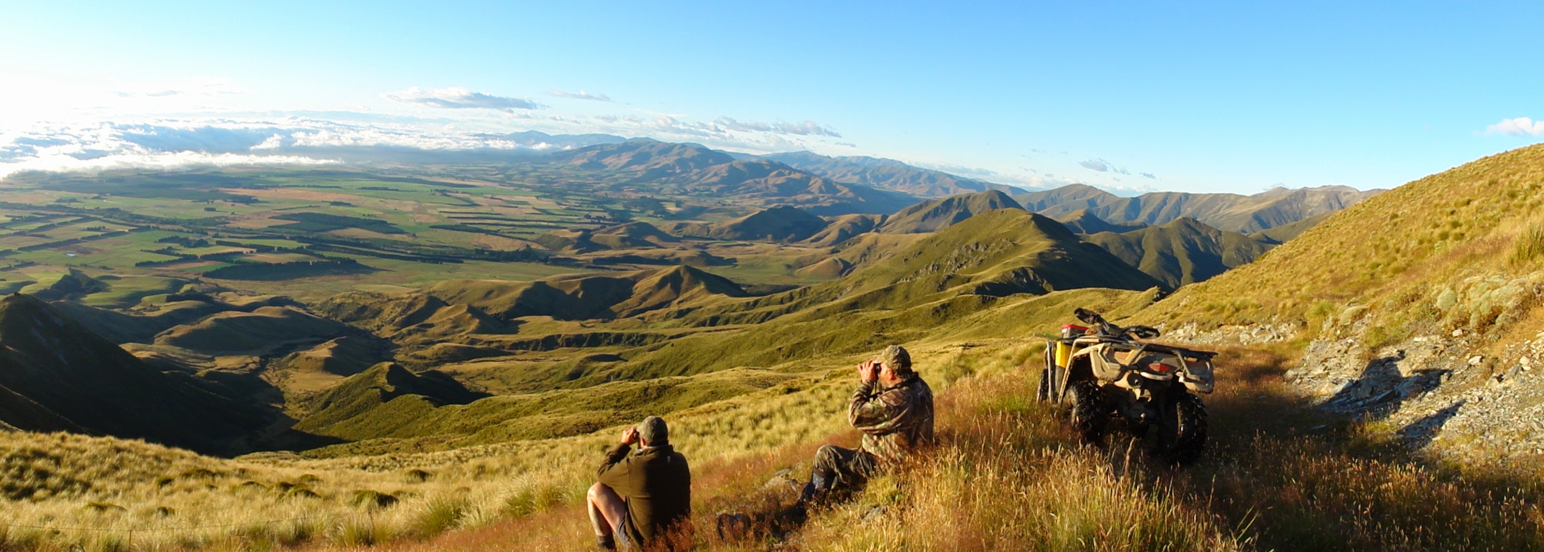 Hunters glassing a mountain valley